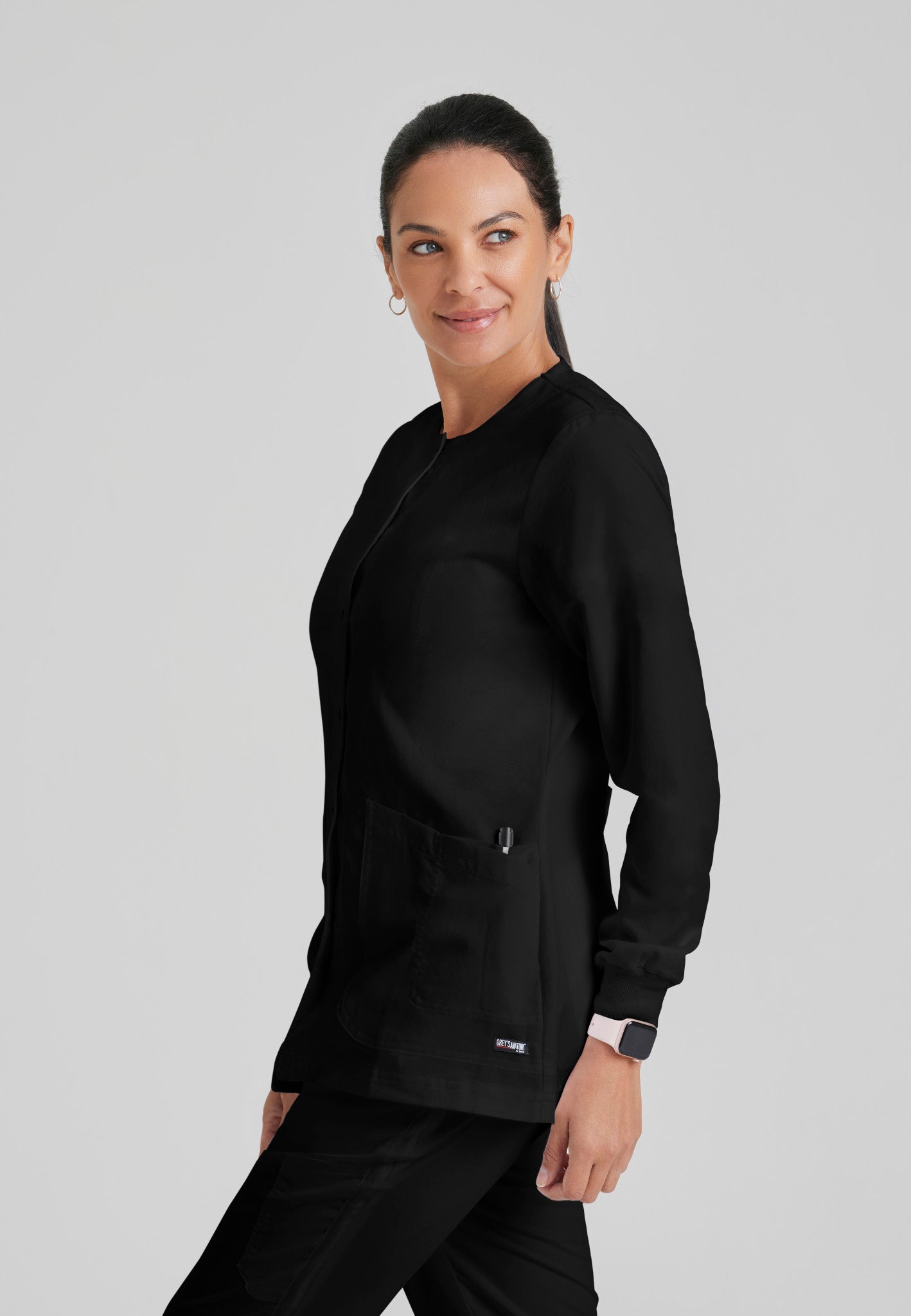 Side view of Grey's Anatomy Jamie Warm Up Scrub Jacket in Black colour.