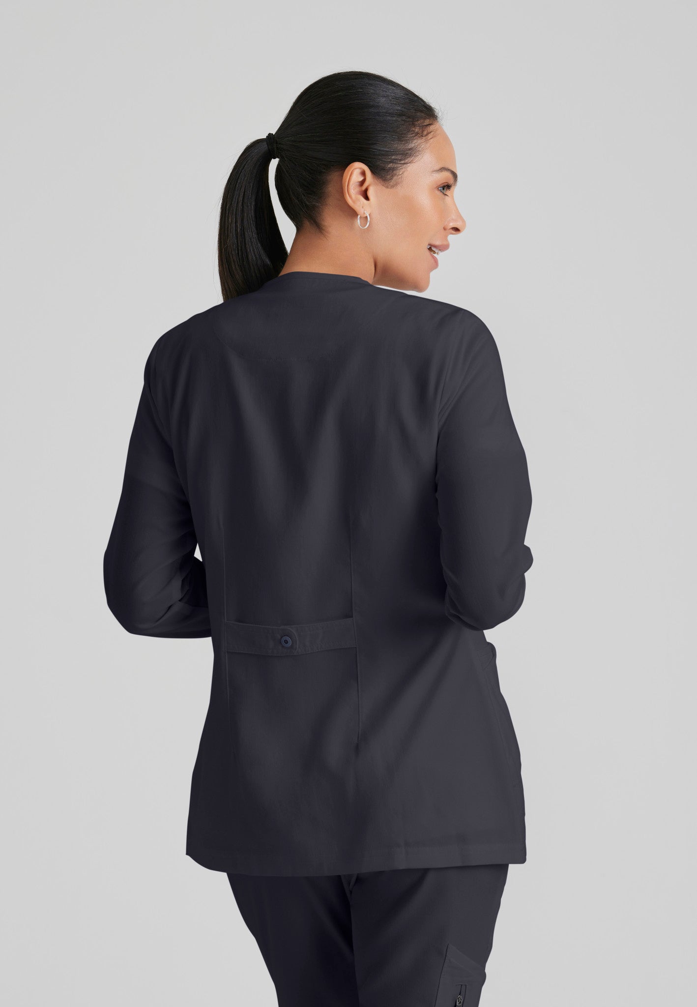 Back view of Grey's Anatomy Jamie Warm Up Scrub Jacket in Steel colour.