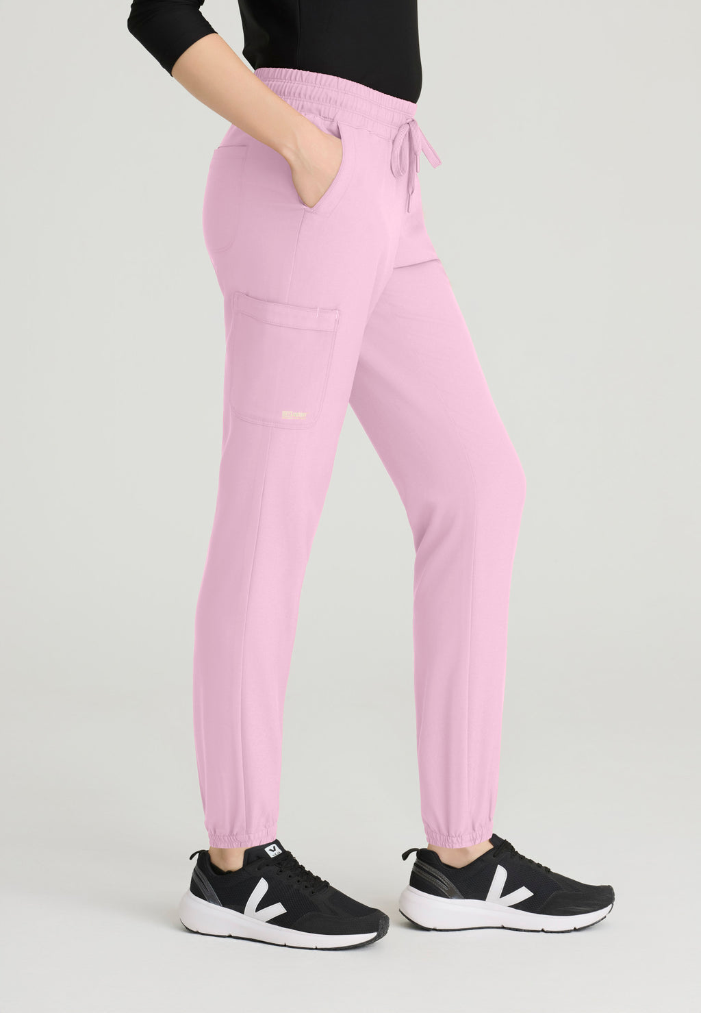 Side view of the Grey's Anatomy Evolve women's Terra scrub jogger in the colour Misty Pink.