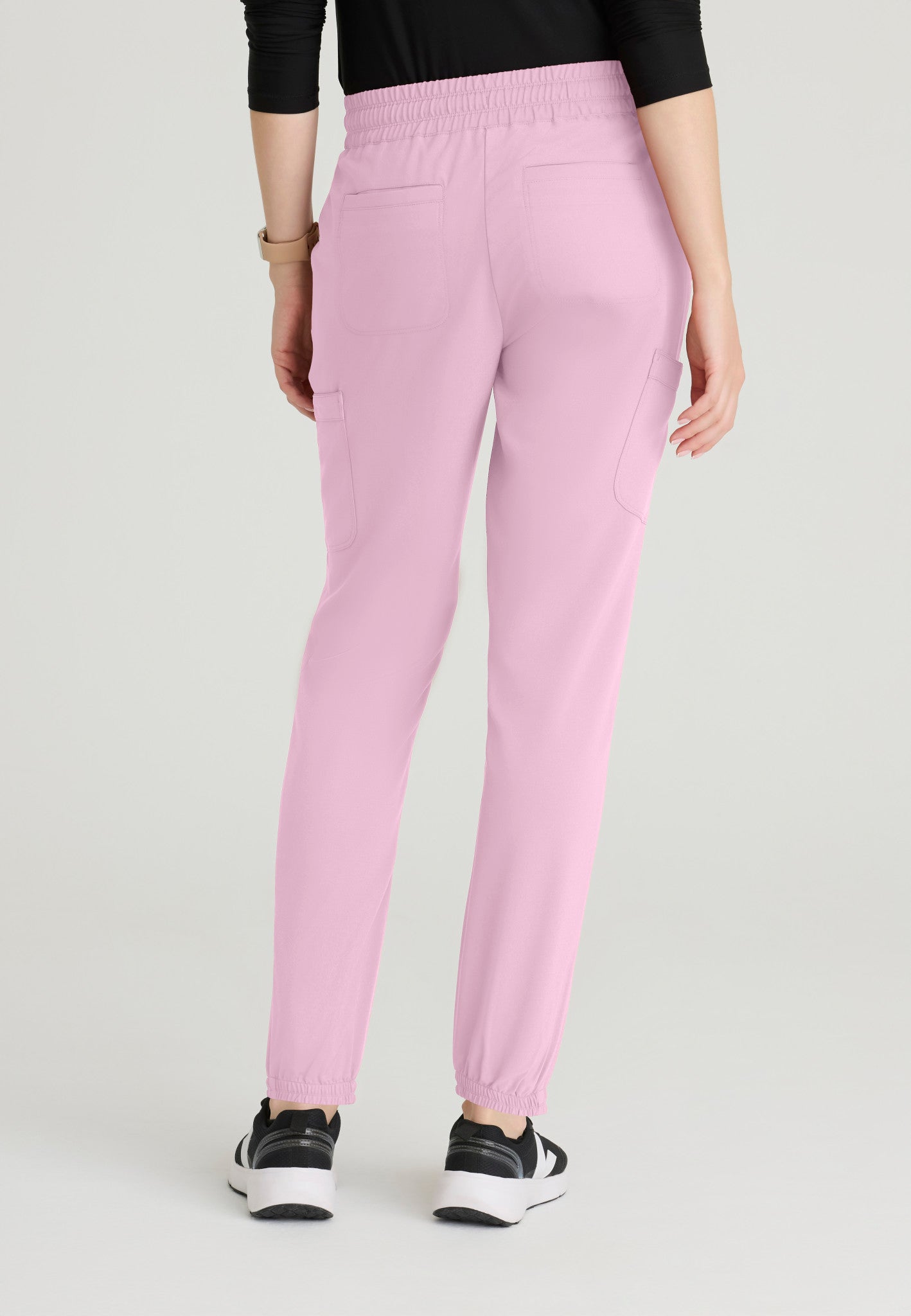 Back view of the Grey's Anatomy Evolve women's Terra scrub jogger in the colour Misty Pink.