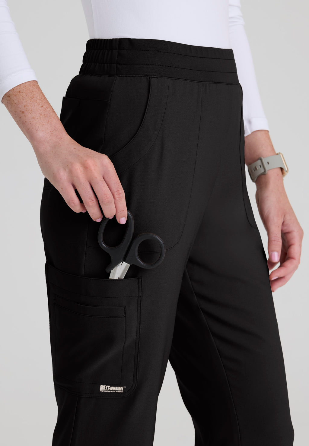 Close up view of the Grey's Anatomy Evolve women's Sky scrub pant in the colour Black.