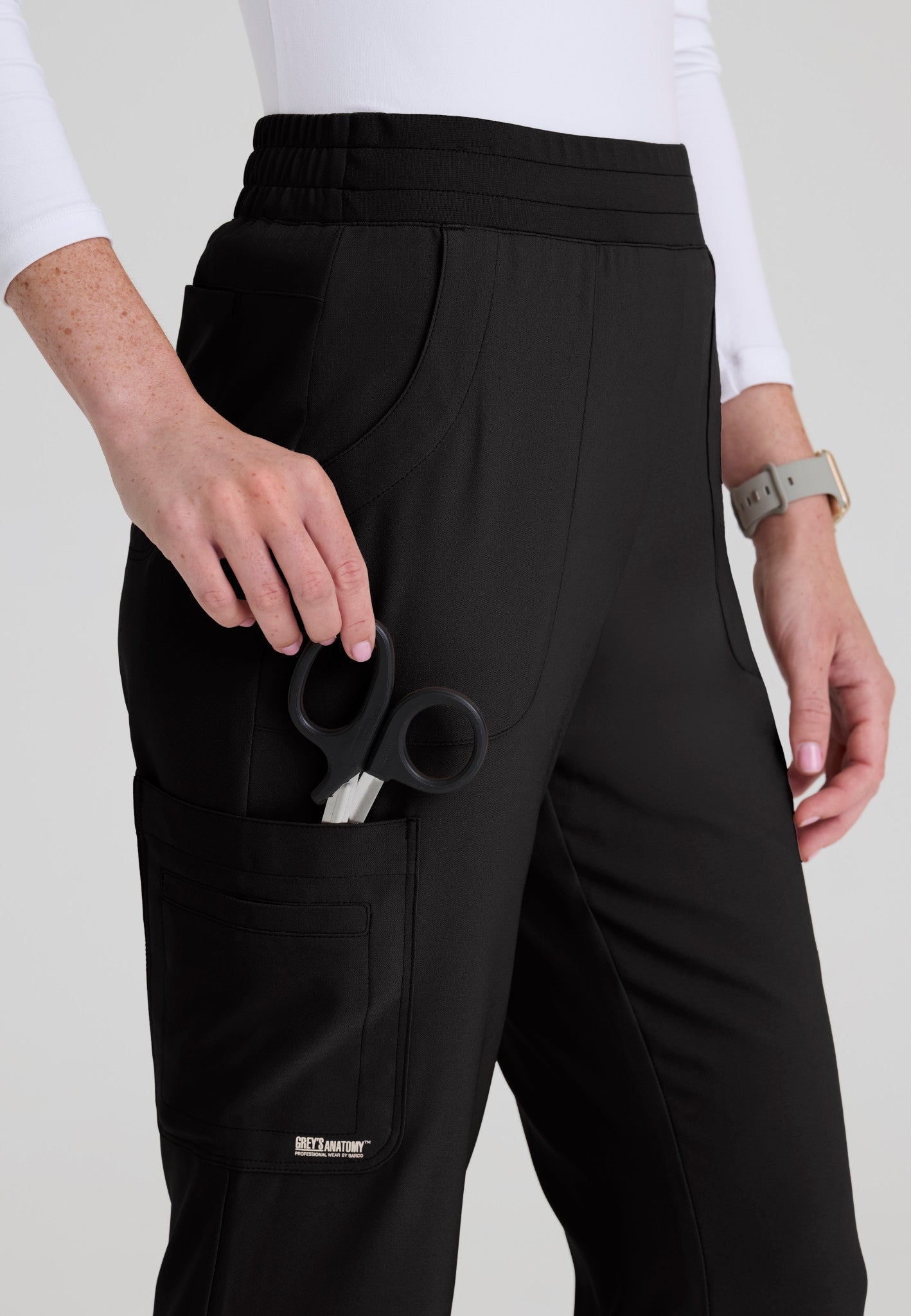Close up view of the Grey's Anatomy Evolve women's Sky scrub pant in the colour Black.