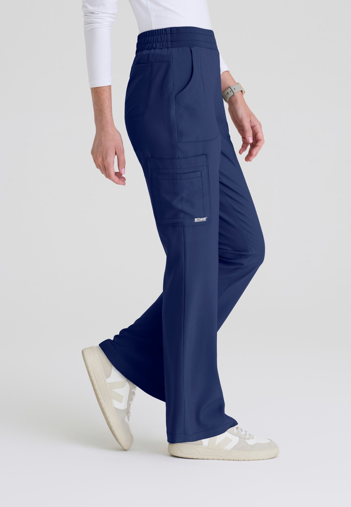 Side view of the Grey's Anatomy Evolve women's Sky scrub pant in the colour Indigo.