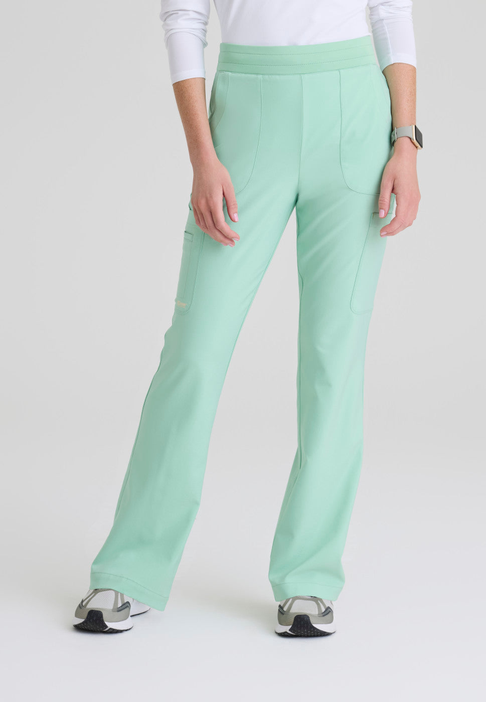 Front view of the GSSP729 Grey's Anatomy Evolve Sky Fit and Flare Scrub pant in the colour Soft Melon.