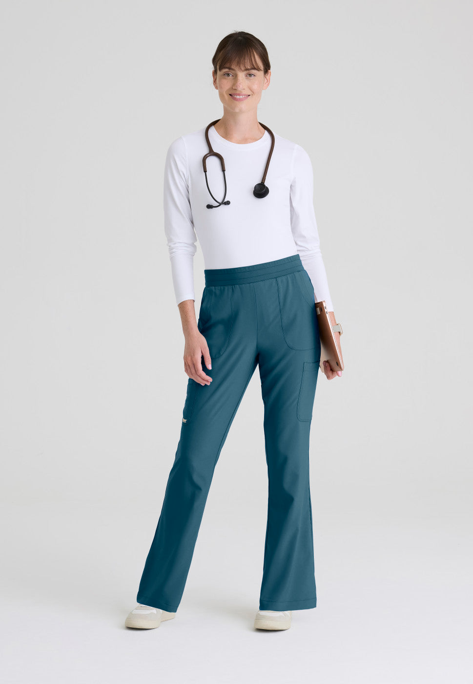 Full view of the GSSP729 Grey's Anatomy Evolve Sky Fit and Flare Scrub pant in the colour Bahama.