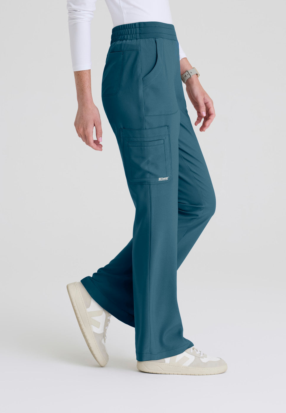 Side view of the GSSP729 Grey's Anatomy Evolve Sky Fit and Flare Scrub pant in the colour Bahama.