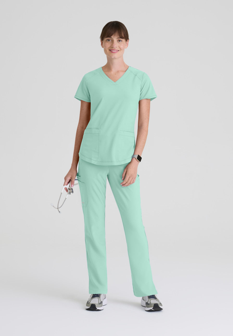 Full view of the GSST180 Grey's Anatomy Evolve Women's Scrub Top in the colour soft melon.