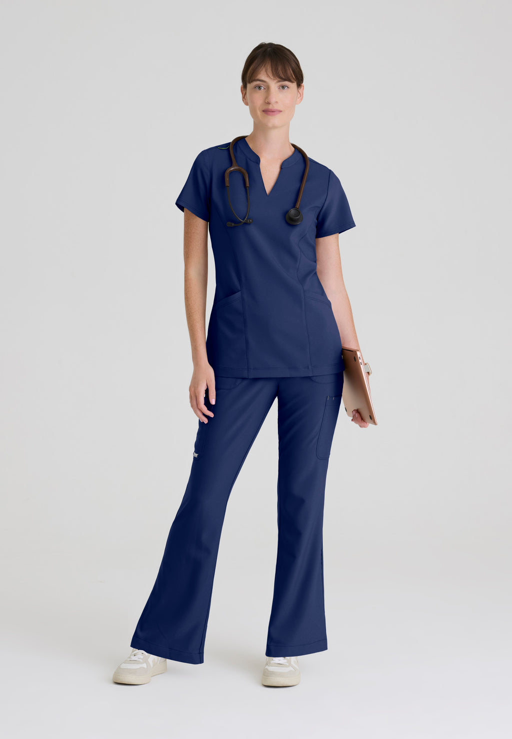 Full view of the Grey's Anatomy Evolve women's Sky scrub top in the colour Indigo.