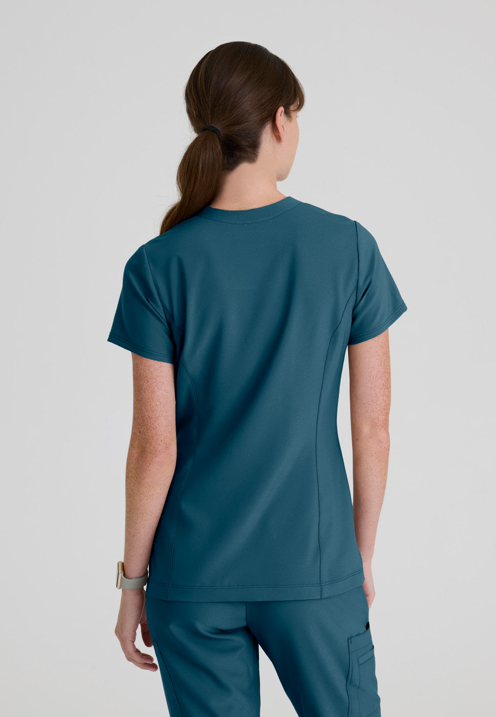 Back view of the GSST298 Grey's Anatomy Evolve Sky Banded Scrub Top in the colour Bahama.