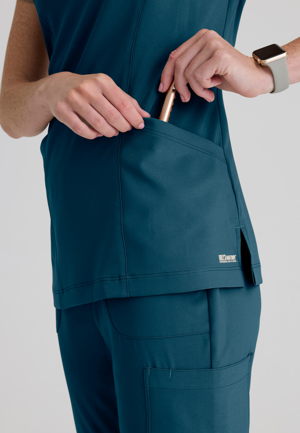 Close up view of the GSST298 Grey's Anatomy Evolve Sky Banded Scrub Top in the colour Bahama.