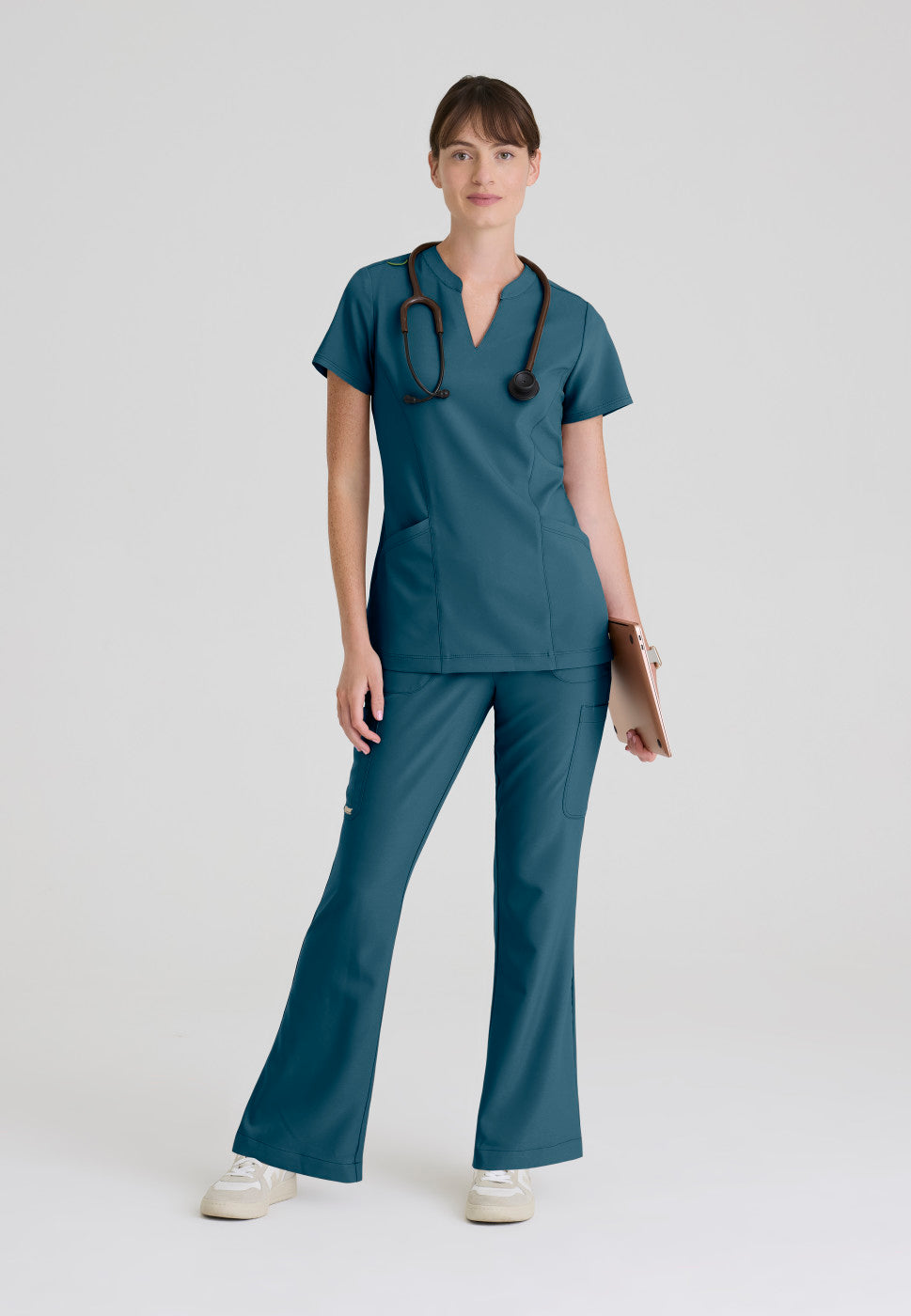 Full view of the GSST298 Grey's Anatomy Evolve Sky Banded Scrub Top in the colour Bahama.