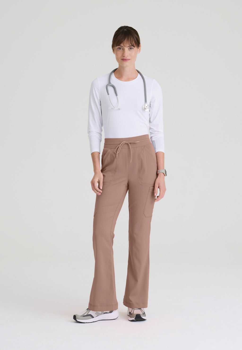 Full view of Kristi women's high-rise scrub pant featuring a fit & flare leg, knit waistband, and 7-pocket design. Mocha colour.