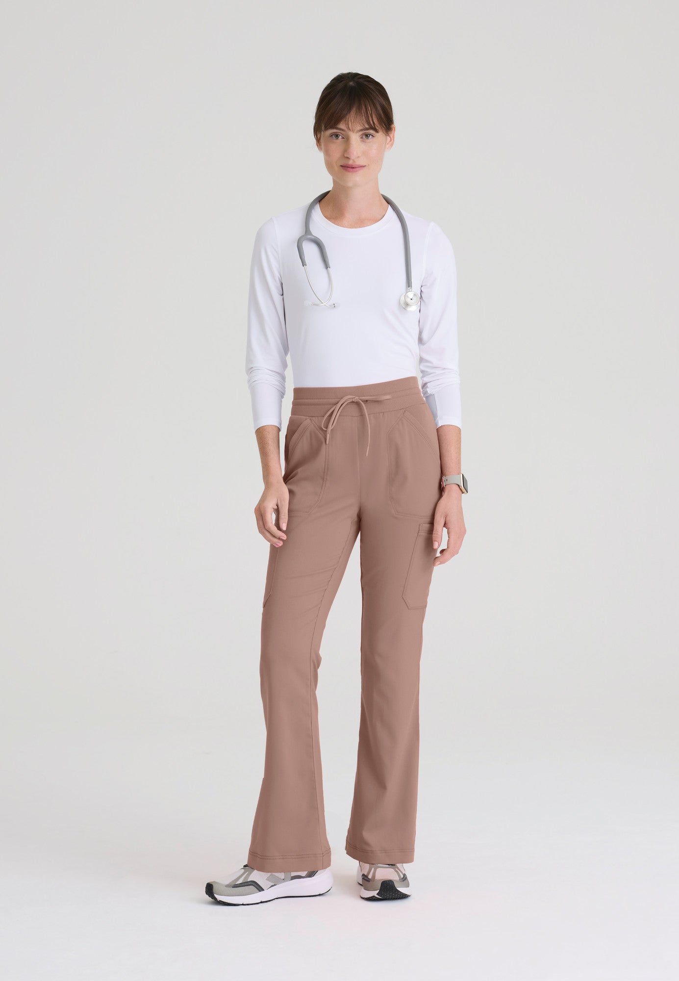 Full view of Kristi women's high-rise scrub pant featuring a fit & flare leg, knit waistband, and 7-pocket design. Mocha colour.