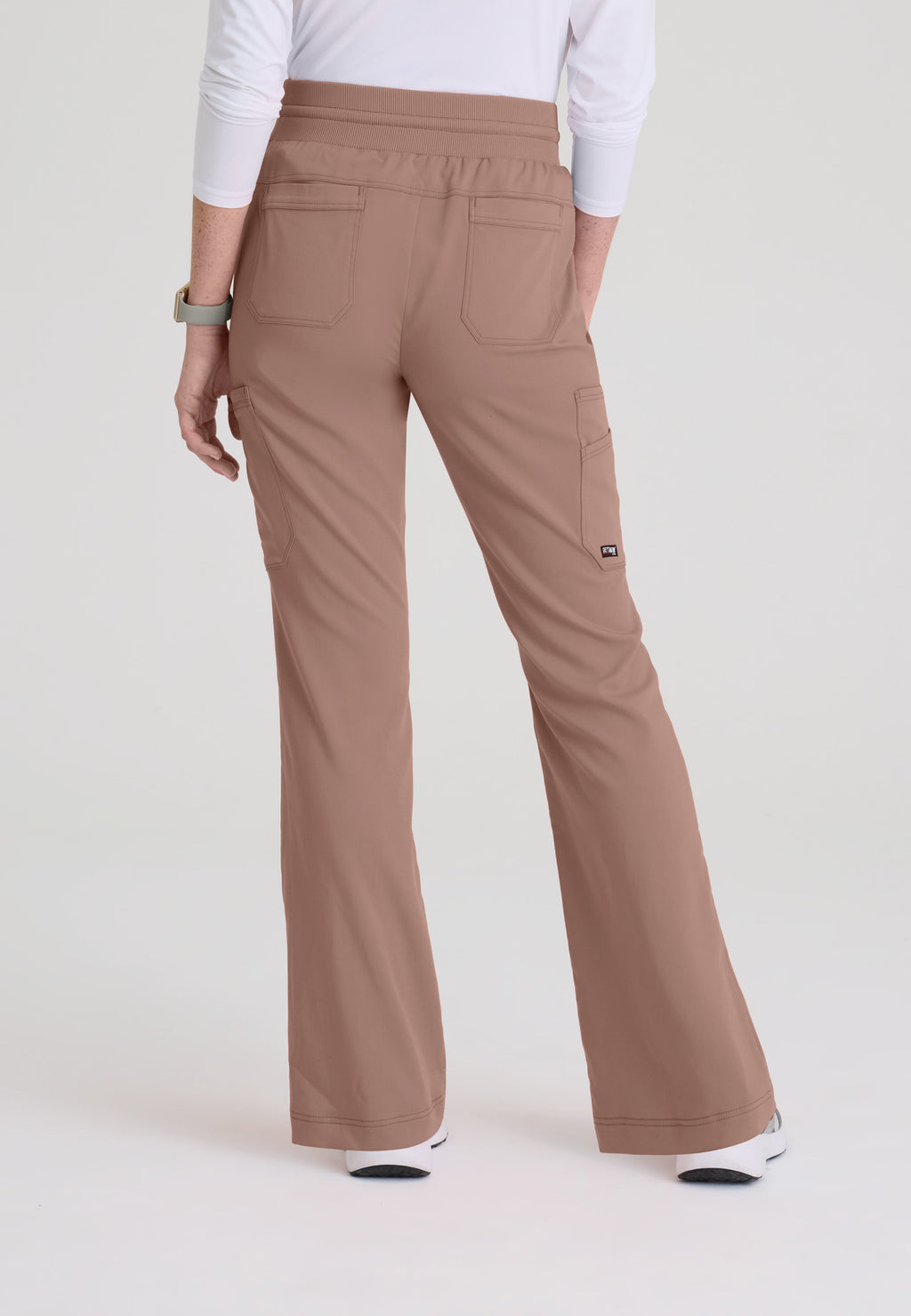 Back view of Kristi fit & flare scrub pant showing rear riser and two back patch pockets. Mocha colour.