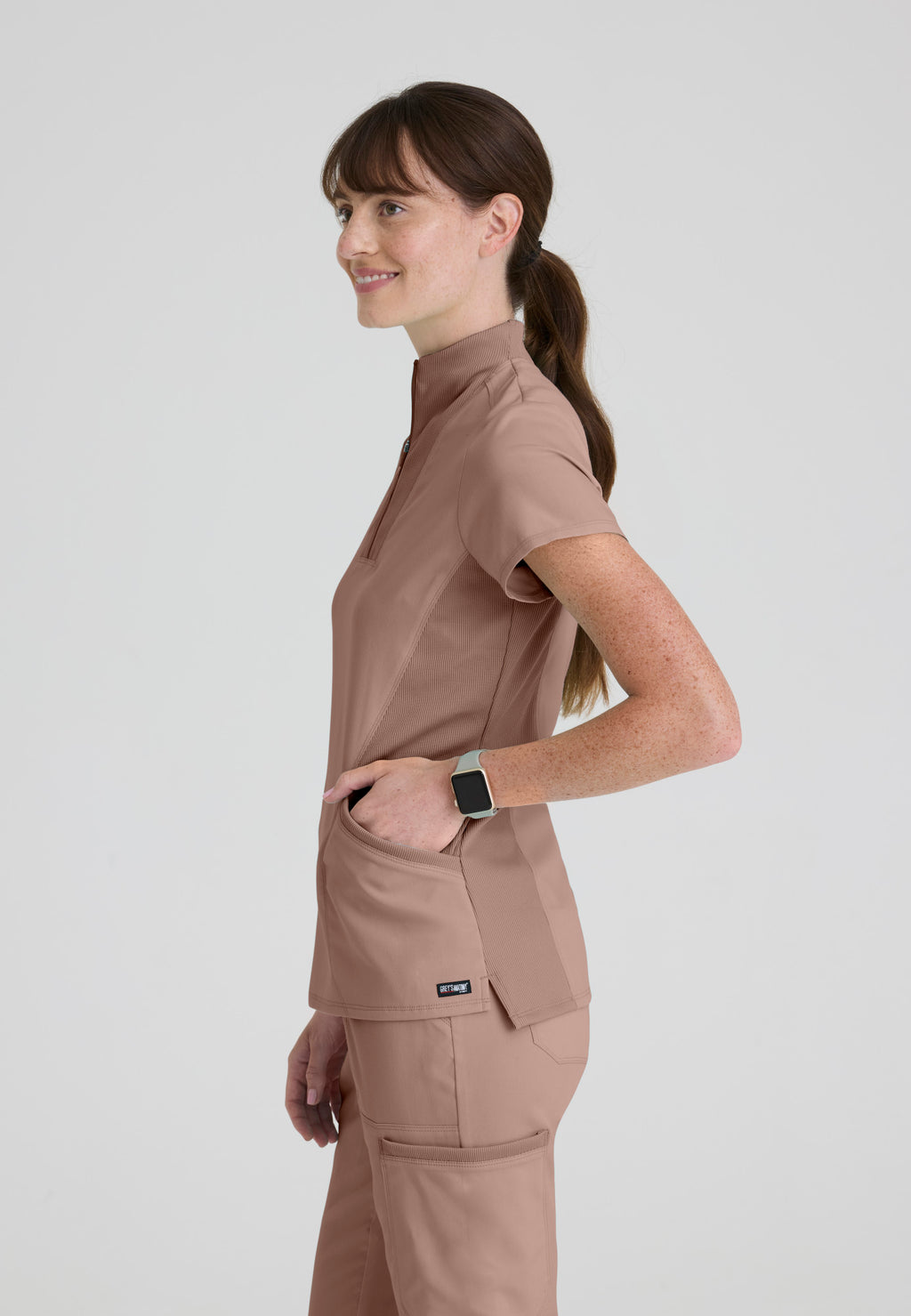 Side view showing flexible rib-knit panels and side vents for movement. Grey's Anatomy Kristi scrub top.  Warm Mocha colour.