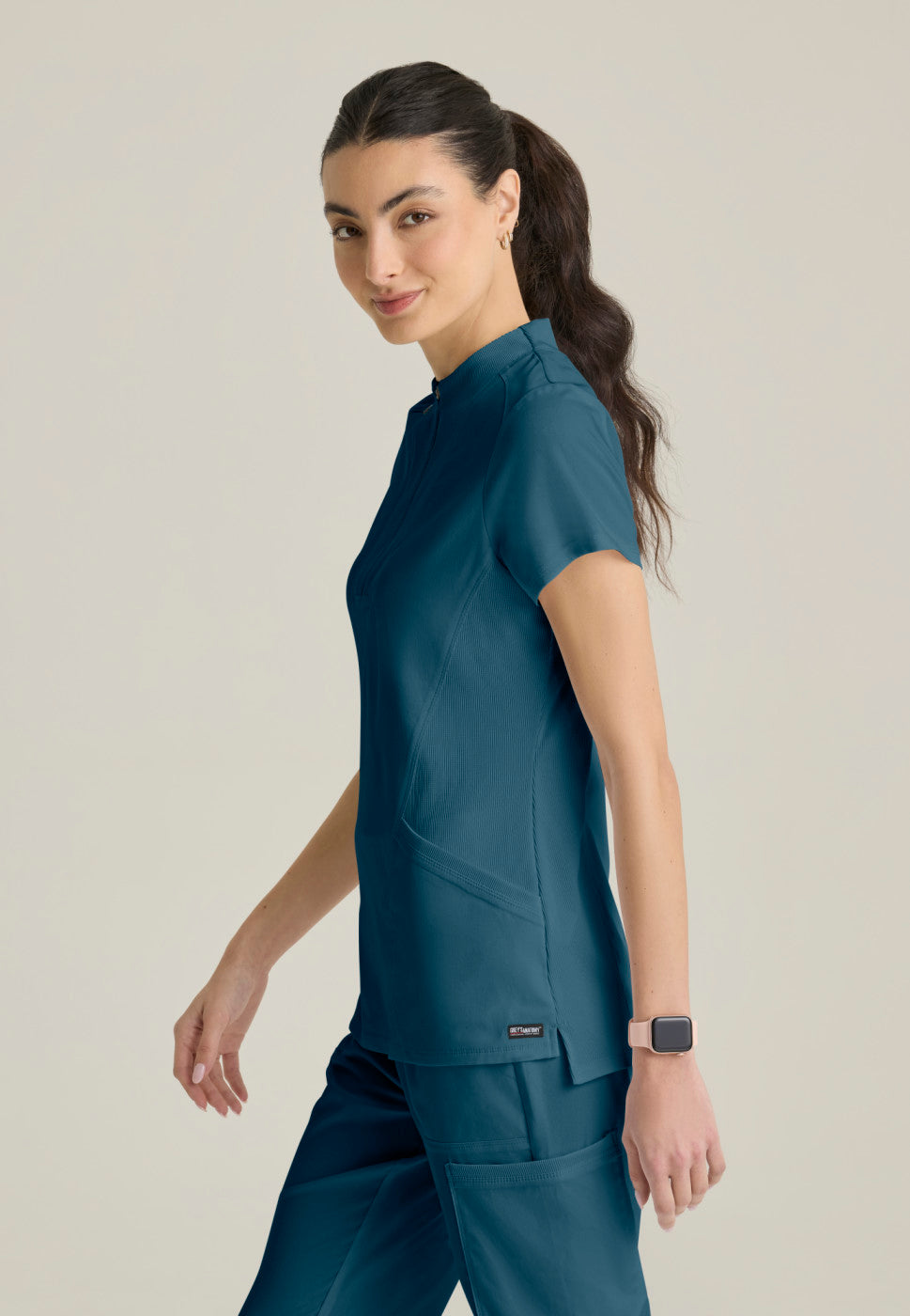 Side view of the GRST292 Women's Grey's Anatomy Kristi Scrub Top in the colour bahama.