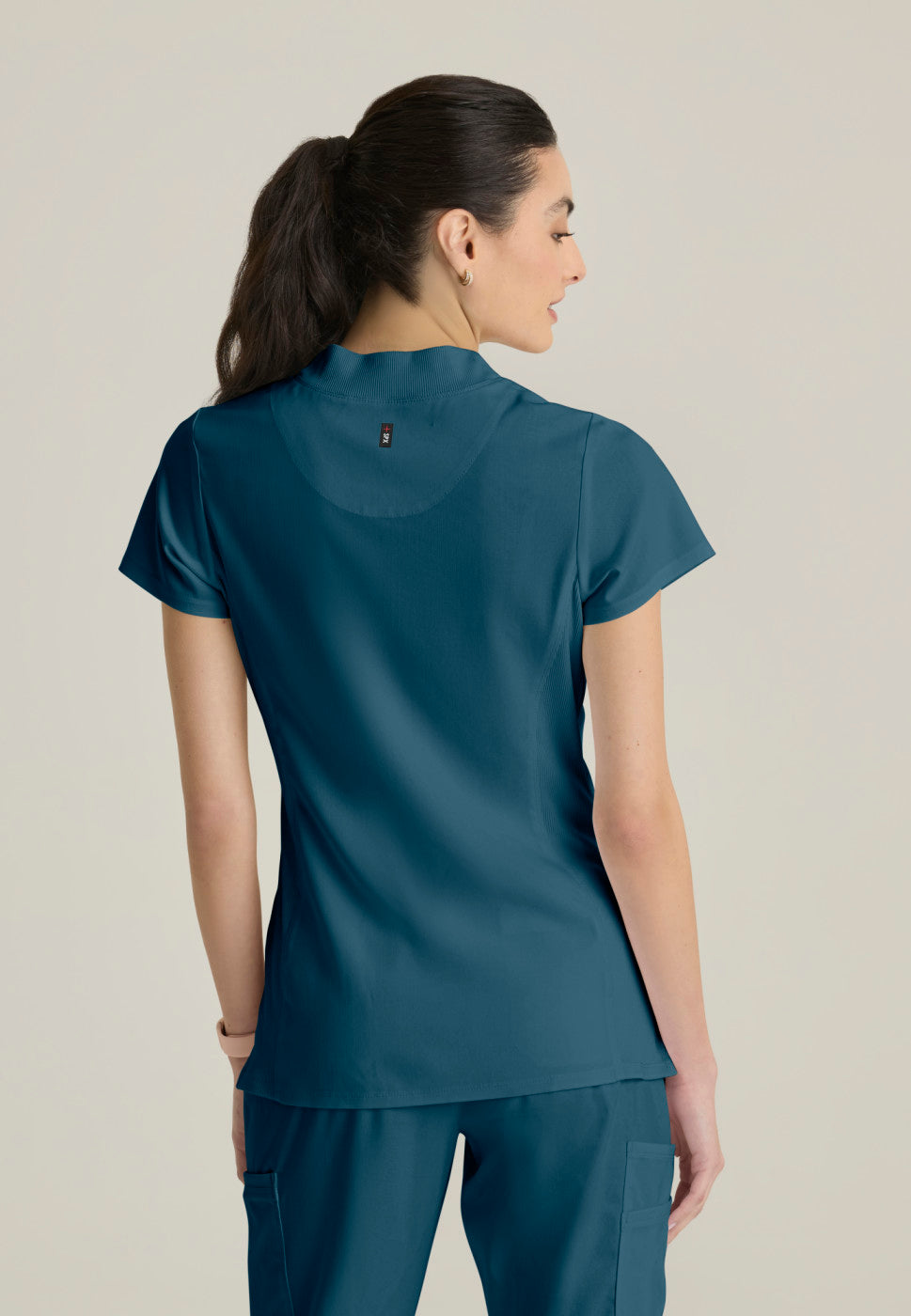 Back view of the GRST292 Women's Grey's Anatomy Kristi Scrub Top in the colour bahama.