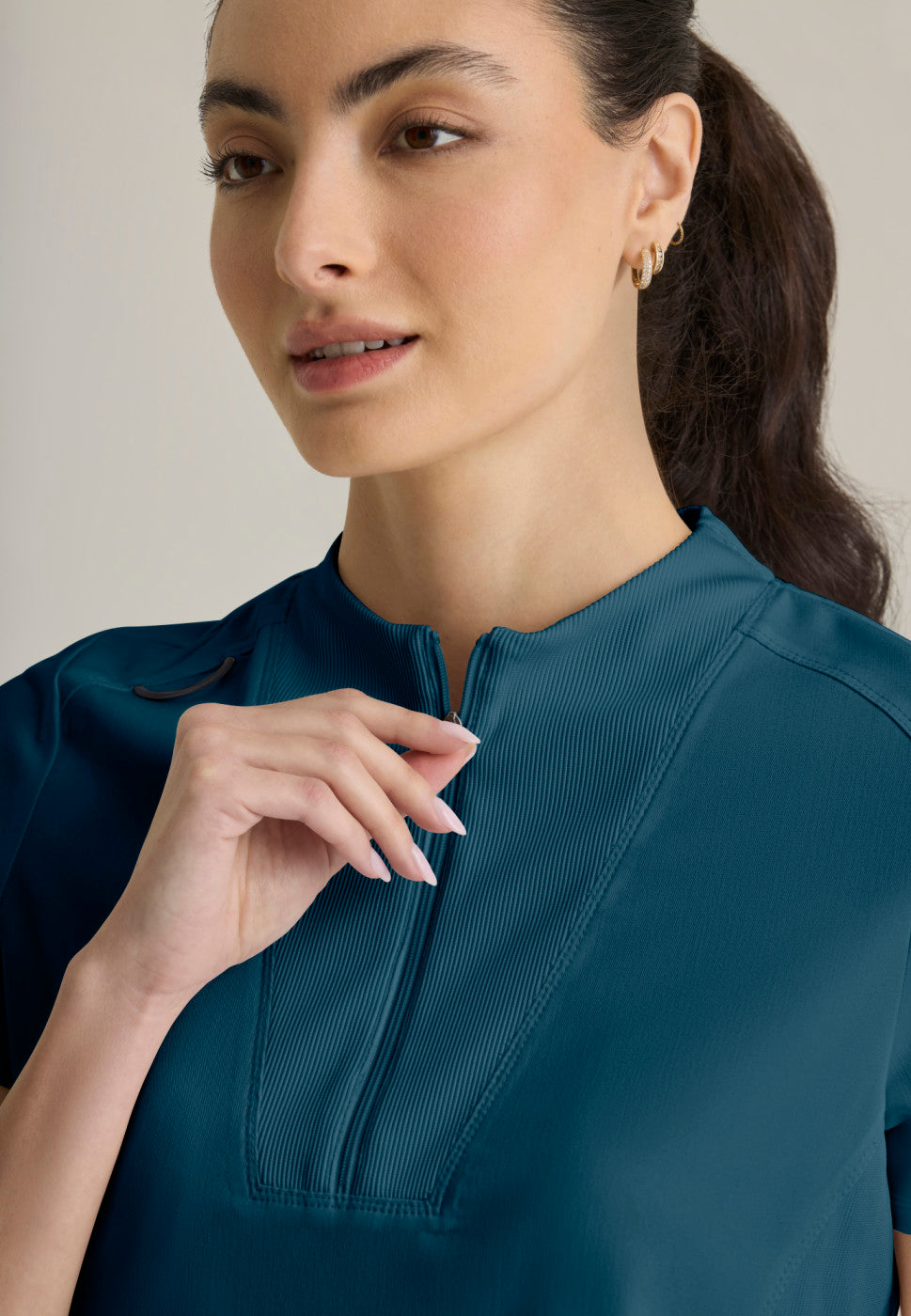 Close up view of the GRST292 Women's Grey's Anatomy Kristi Scrub Top in the colour bahama.