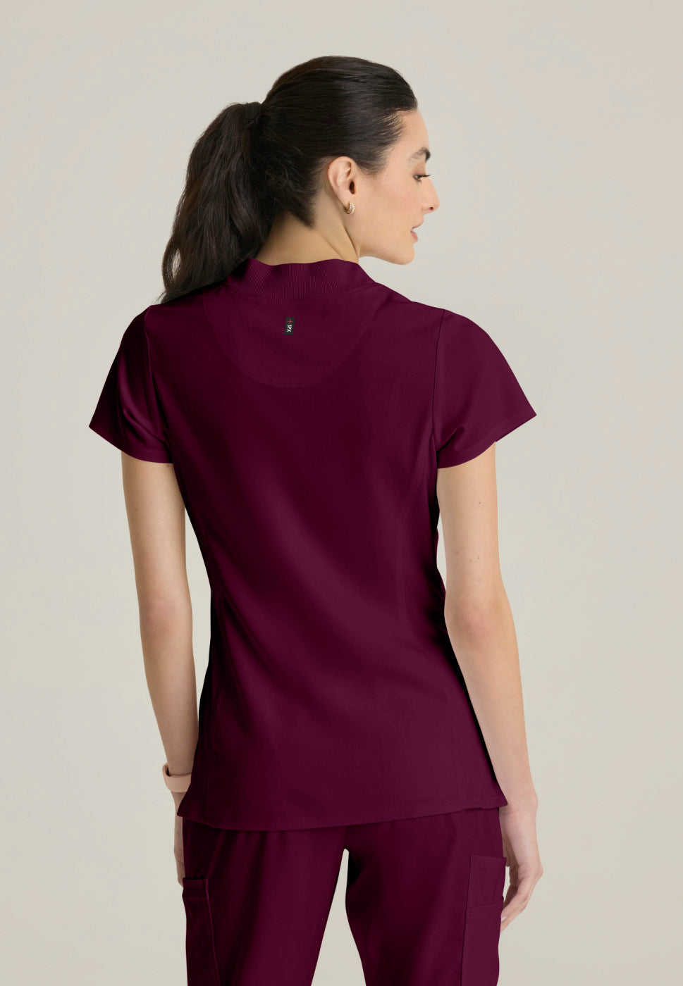 Back view of the GRST292 Women's Grey's Anatomy Kristi Scrub Top in the colour WINE.
