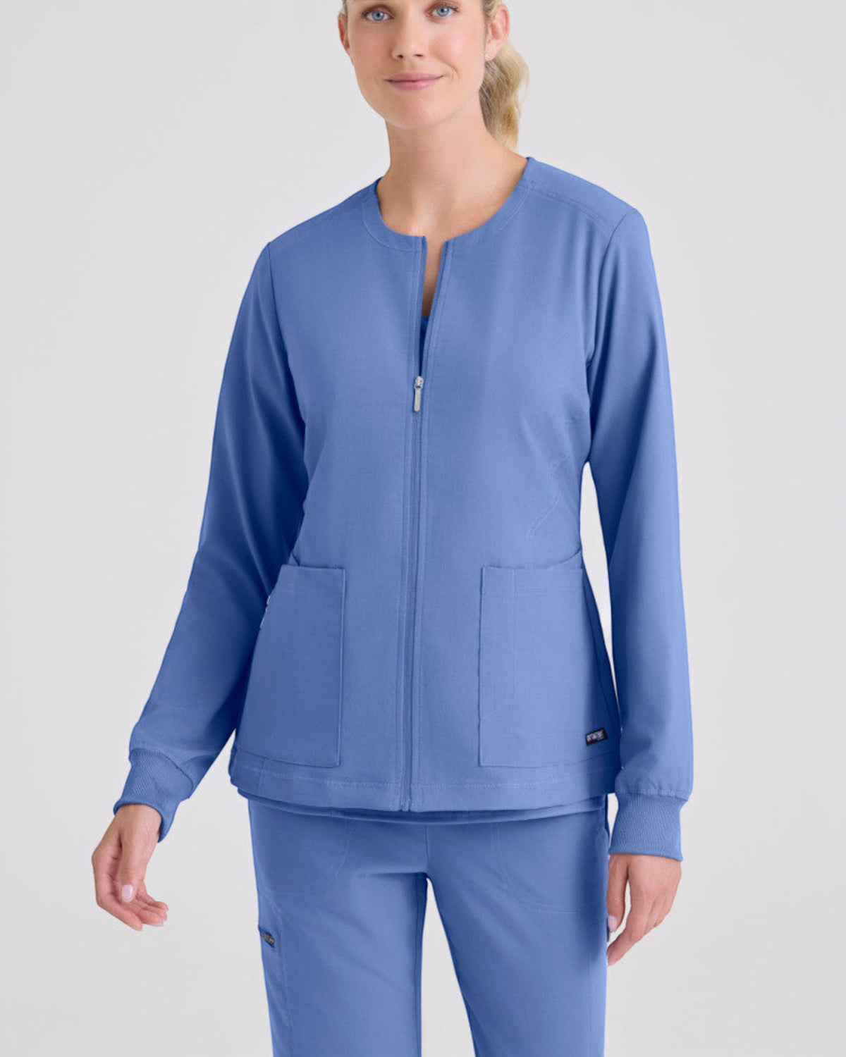 Lasalle Uniform Grey's Anatomy by Barco Gianna blue zip-up scrub jacket with rib-knit cuffs and front pockets