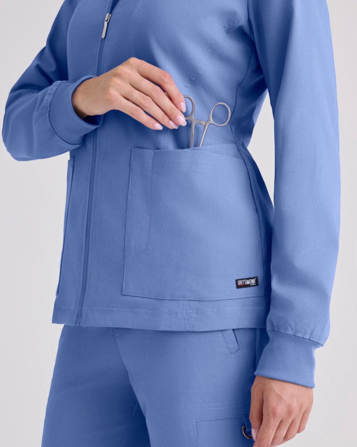 Lasalle Uniform Grey's Anatomy by Barco Gianna blue zip-up scrub jacket with rib-knit cuffs and front pockets