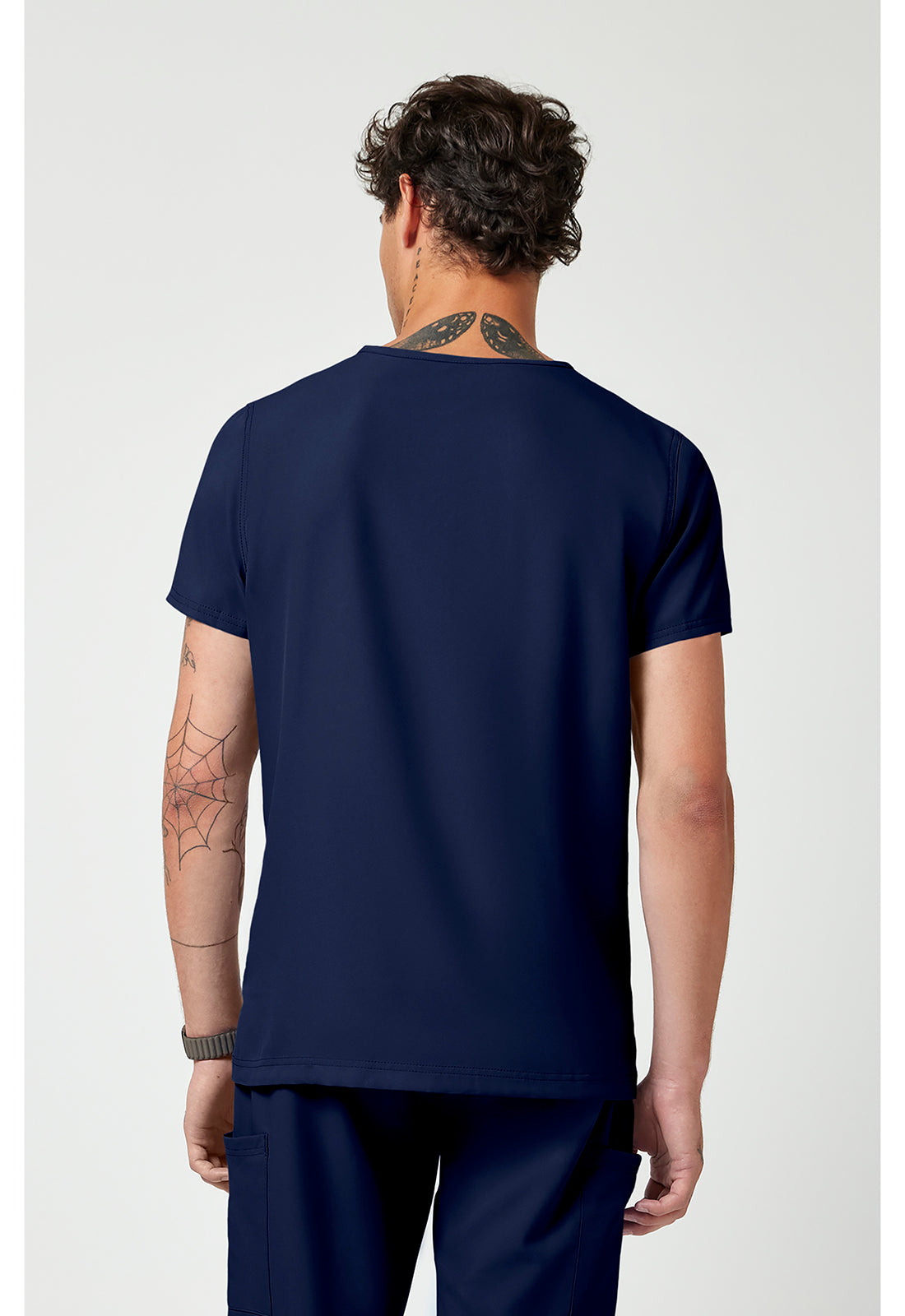 Back view of the Med Couture Rothwear Insight Men's 3-Pocket Scrub Top MC2486 in the colour navy.