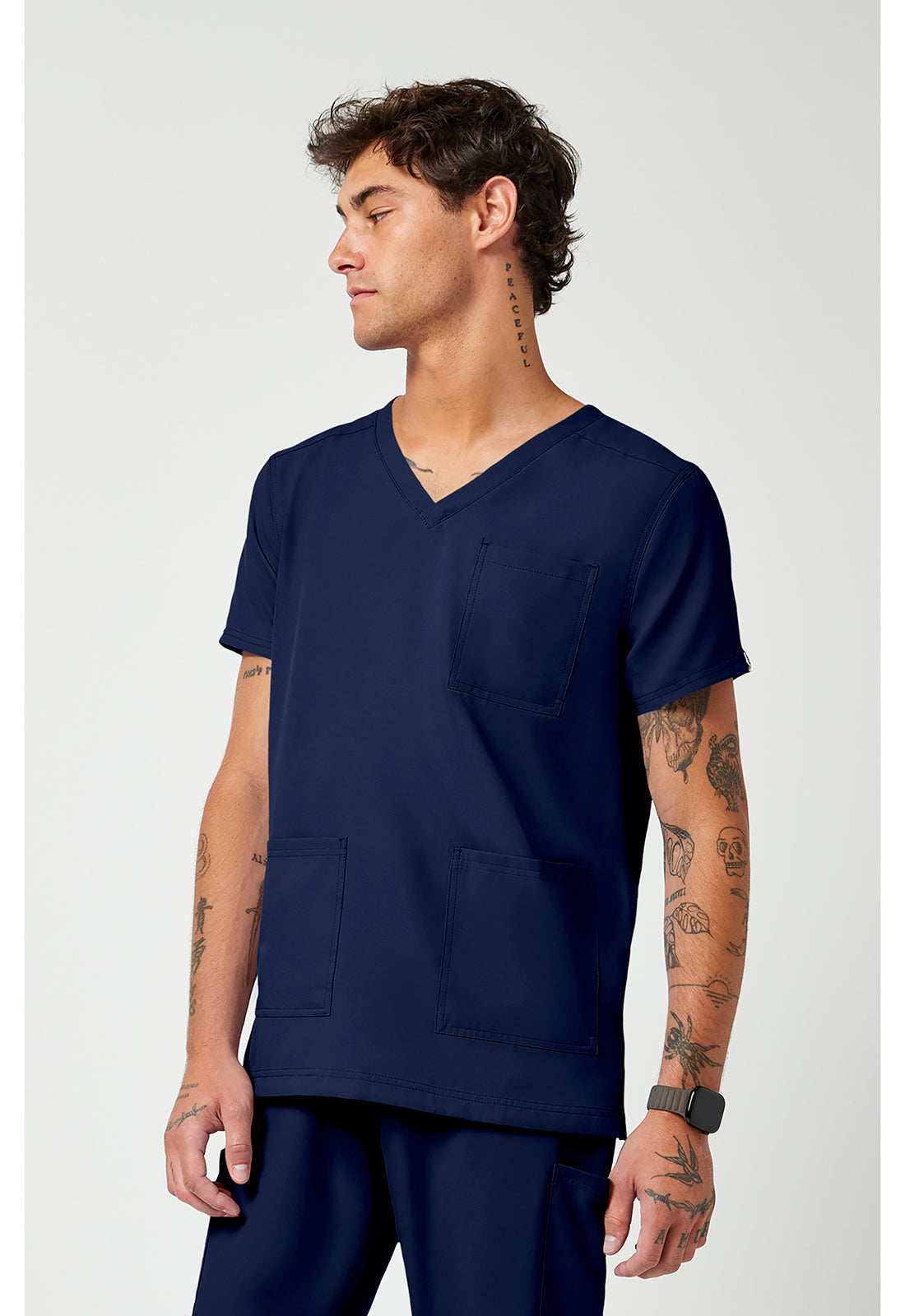Side view of the Med Couture Rothwear Insight Men's 3-Pocket Scrub Top MC2486 in the colour navy.