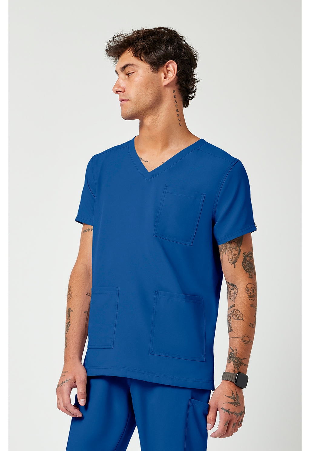 Side view of the Med Couture Rothwear Insight Men's 3-Pocket Scrub Top MC2486 in the colour royal blue.