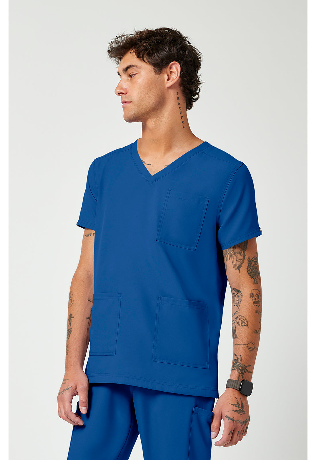 Side view of the Med Couture Rothwear Insight Men's 3-Pocket Scrub Top MC2486 in the colour royal blue.