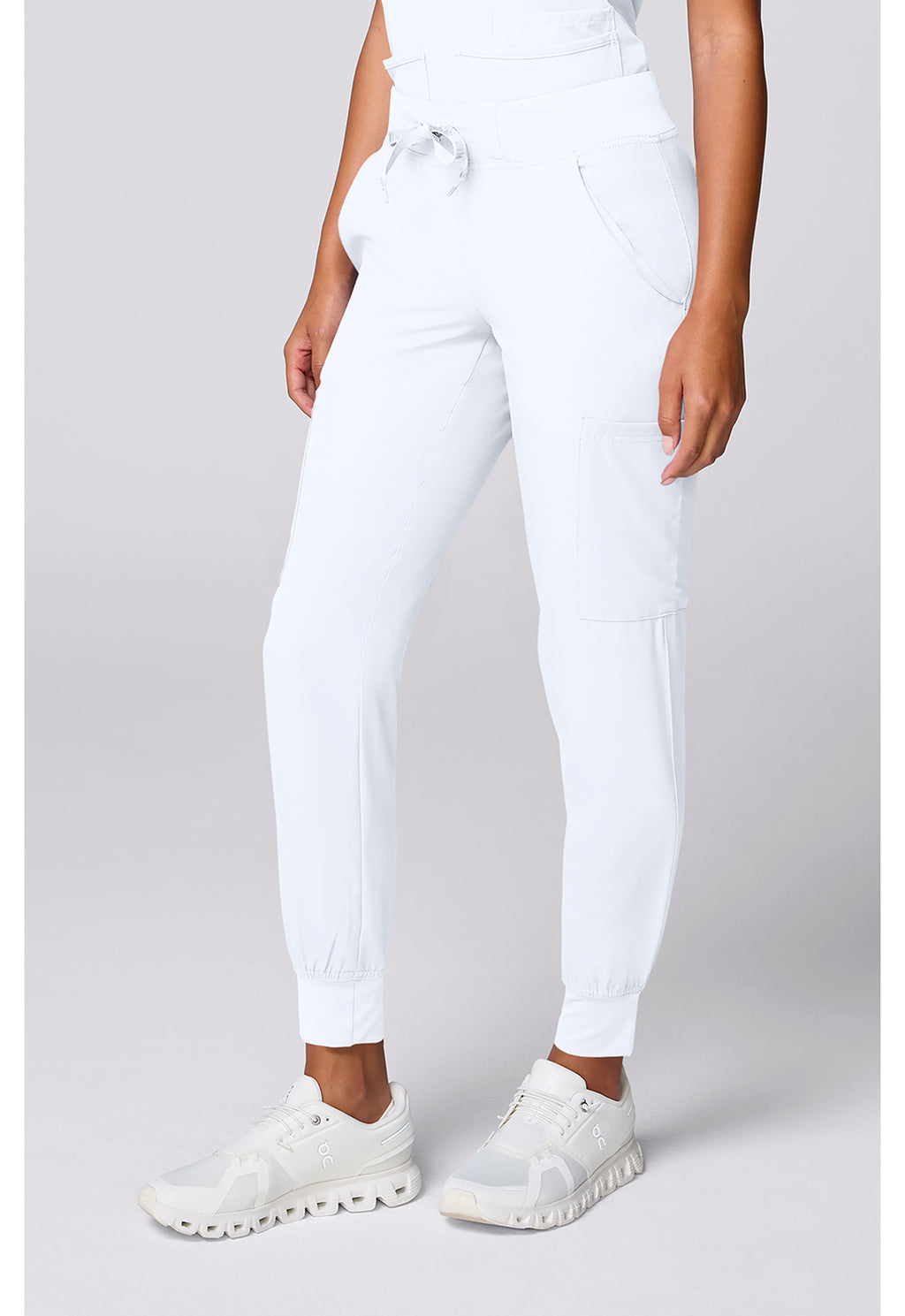 Insight 6-Pocket Scrub Jogger by MED COUTURE Insight in white with six pockets and elastic cuffs styled as medical workwear