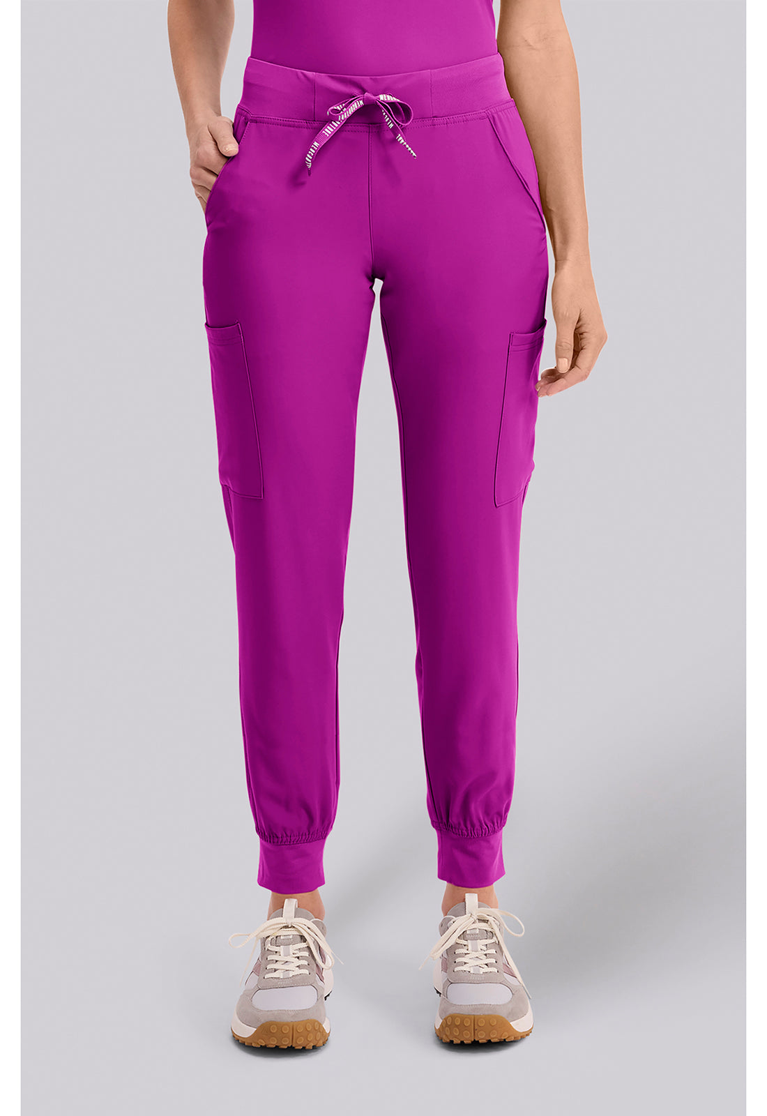 Insight 6-Pocket Scrub Jogger in vibrant magenta with drawstring waist and jogger cuffs shown on a model from MED COUTURE Insight Scrub workwear