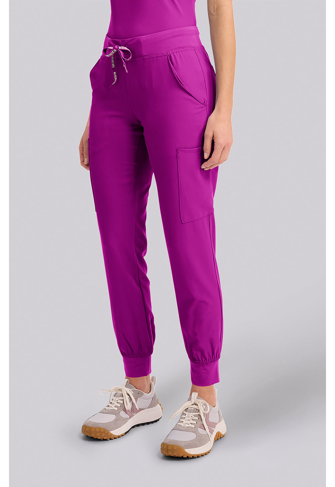 Insight 6-Pocket Scrub Jogger in magenta with six pockets and elastic cuffs modeled with athletic shoes by MED COUTURE Insight