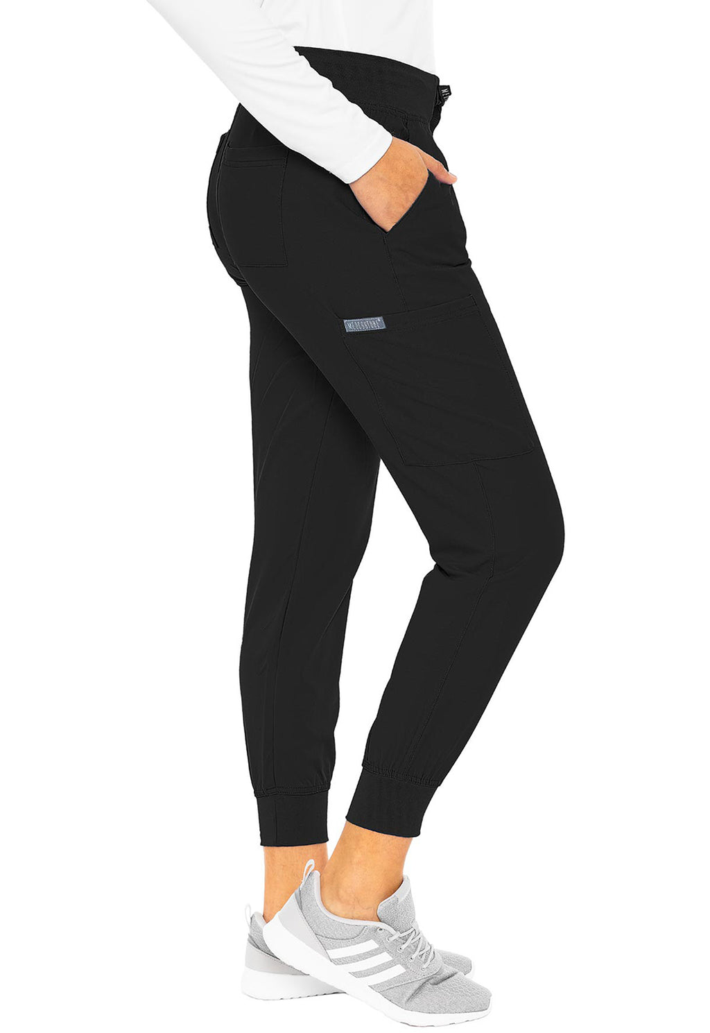 Insight 6-Pocket Scrub Jogger in black worn with a white top and athletic shoes by MED COUTURE Insight for comfortable scrub workwear