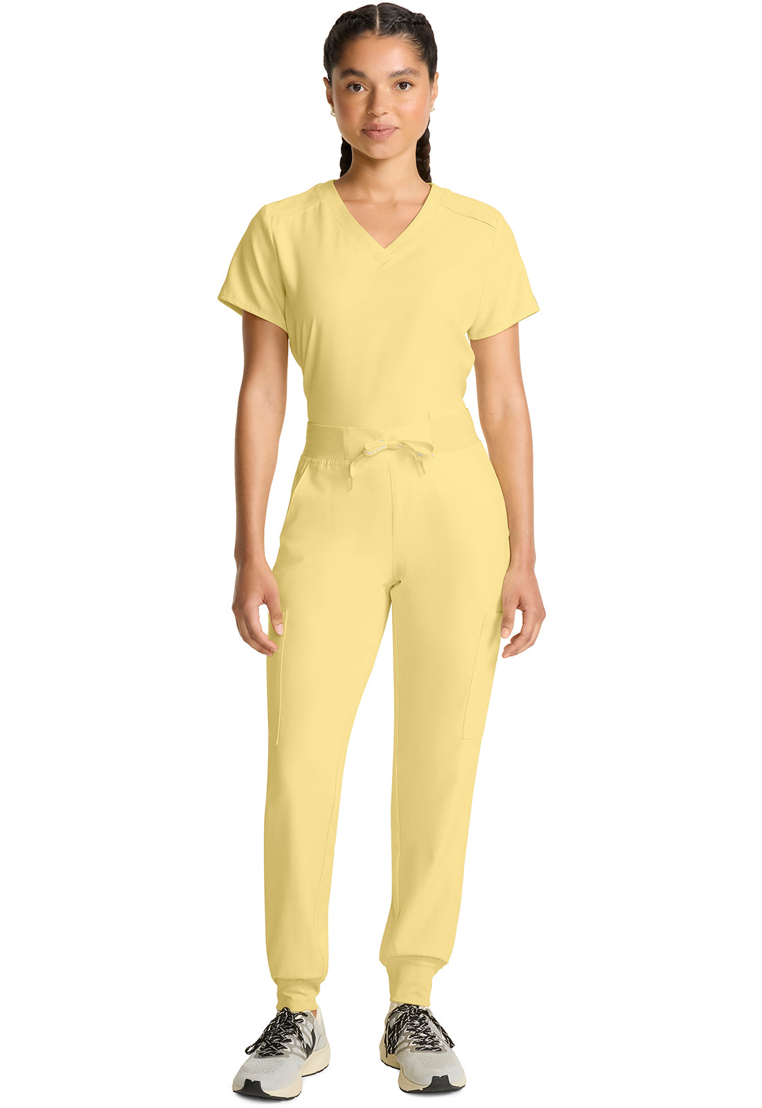 Insight 6-Pocket Scrub Jogger in yellow worn by a model with a matching scrub top and athletic sneakers from MED COUTURE Insight