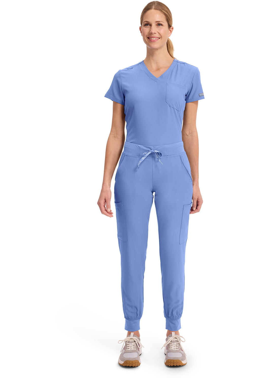Insight 6-Pocket Scrub Jogger in blue worn by a model with a drawstring waist and cuffed ankles from MED COUTURE Insight for comfortable scrub workwear