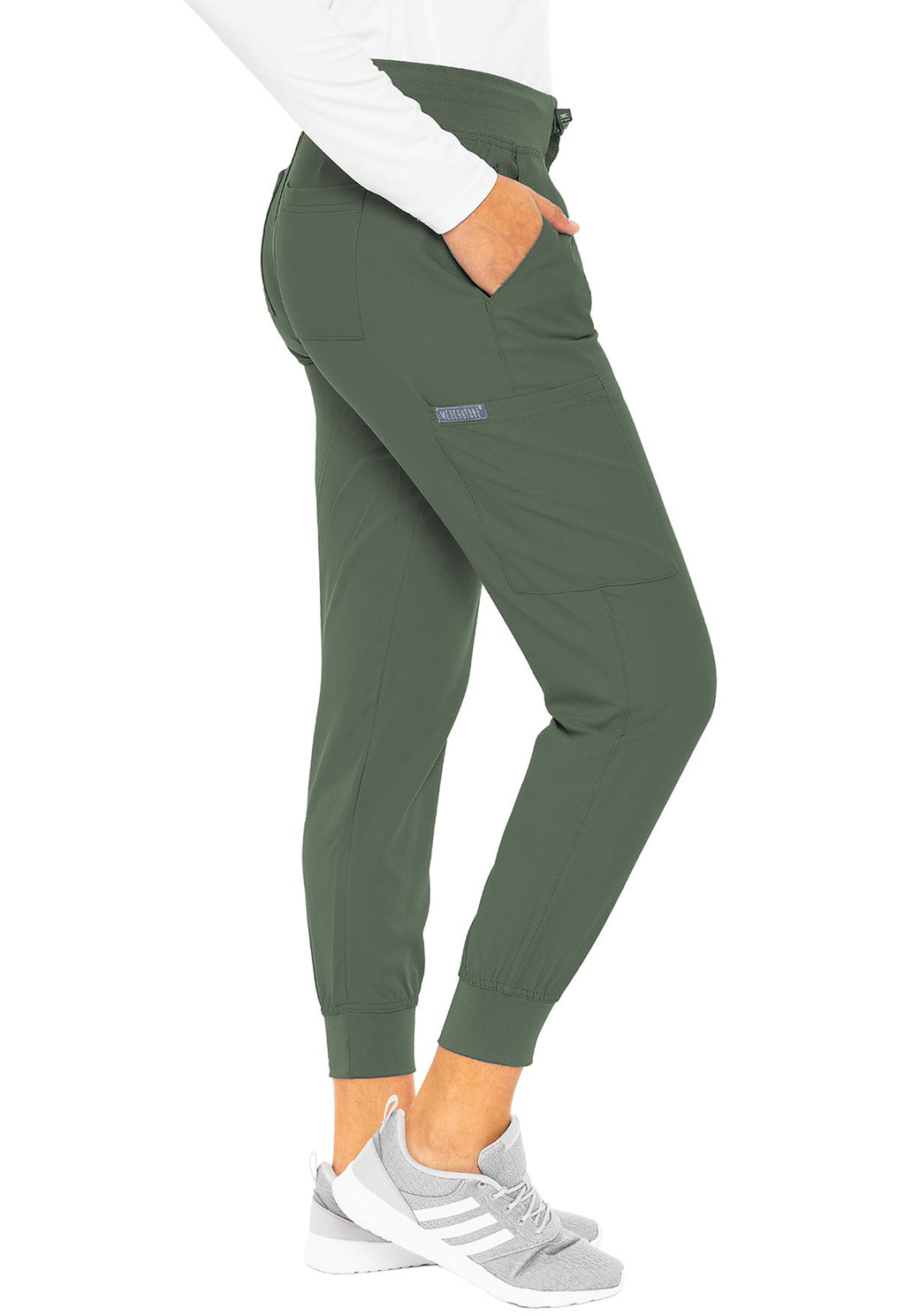 Insight 6-Pocket Scrub Jogger in olive green worn with a white top and gray sneakers by MED COUTURE Insight performance workwear