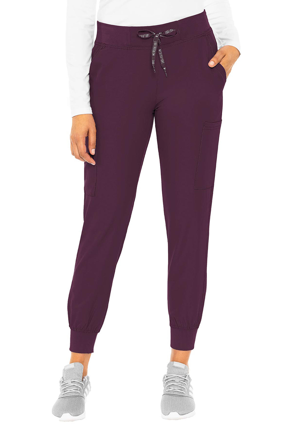 Insight 6-Pocket Scrub Jogger in plum with drawstring waist and ribbed ankle cuffs shown on a model wearing athletic shoes by MED COUTURE Insight