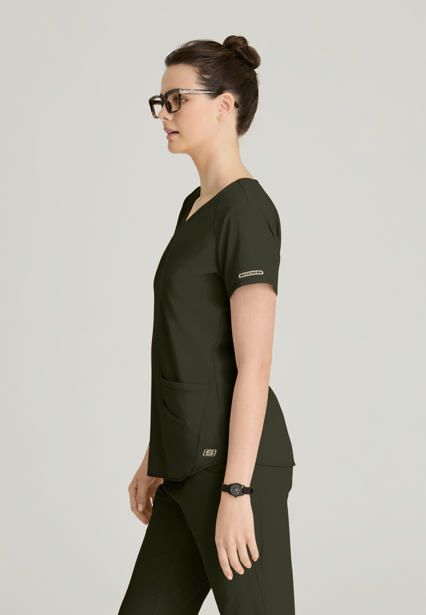 Side view of the SK101 Skechers Breeze women's scrub top in the colour Olive.