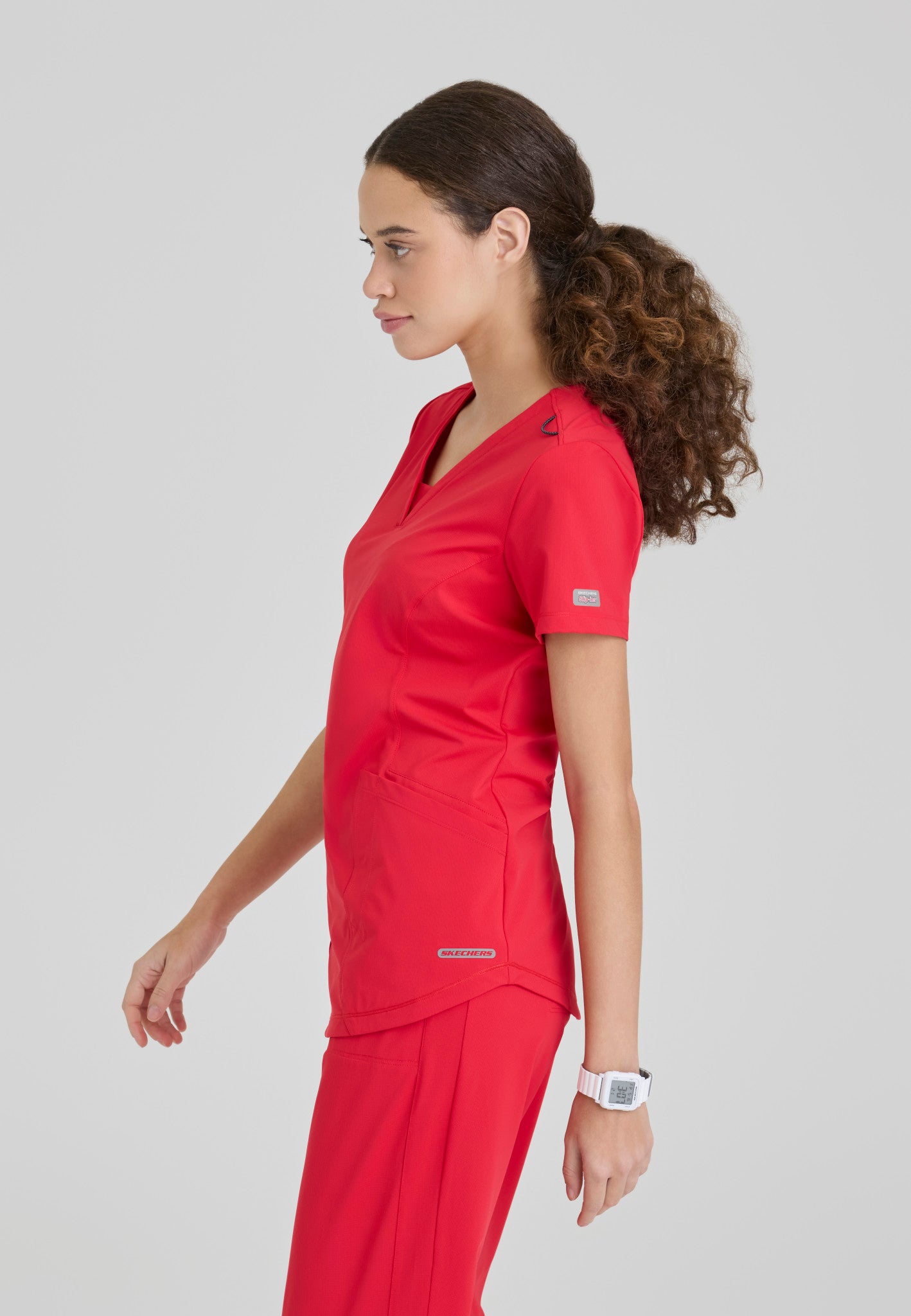 Side view of the Skechers Slip-Ins women's scrub top in the colour Hero.
