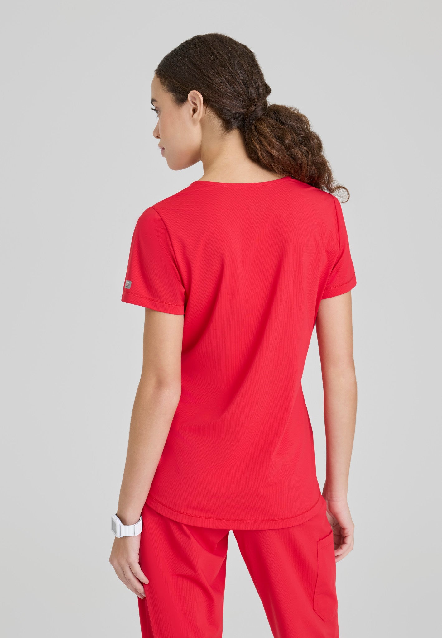 Back view of the Skechers Slip-Ins women's scrub top in the colour Hero.