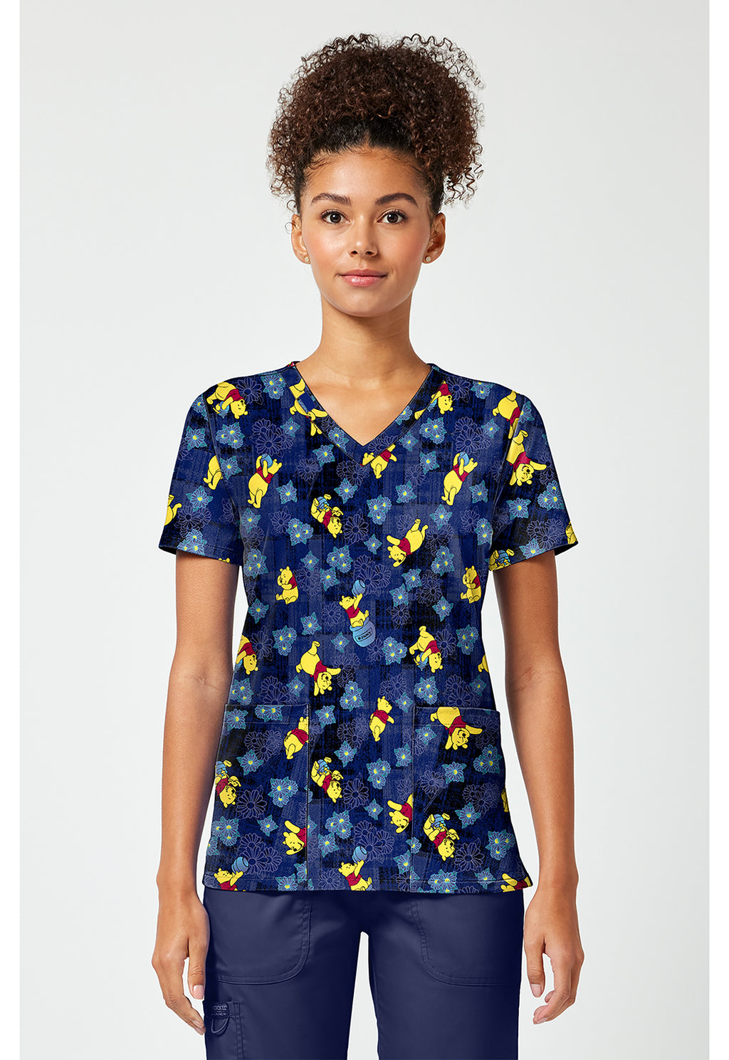 Front view of the Winnie The Pooh Plaid Petals Scrub Top