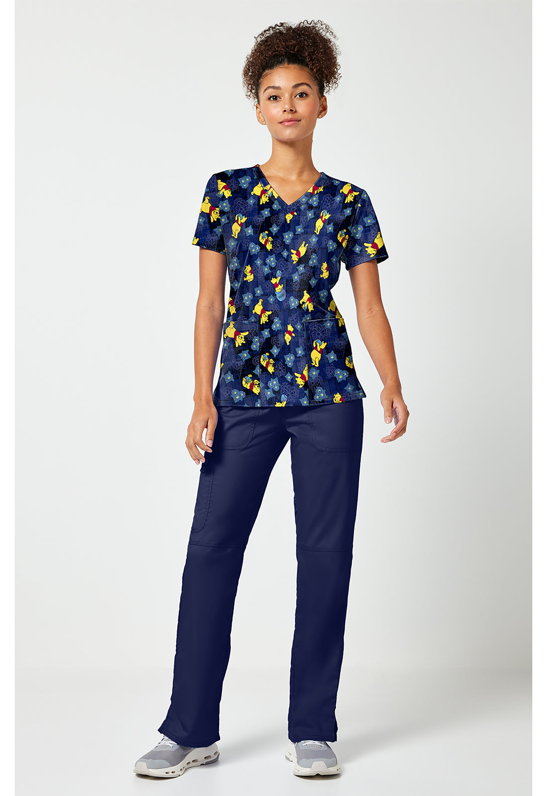 Full view of the Winnie The Pooh Plaid Petals Scrub Top